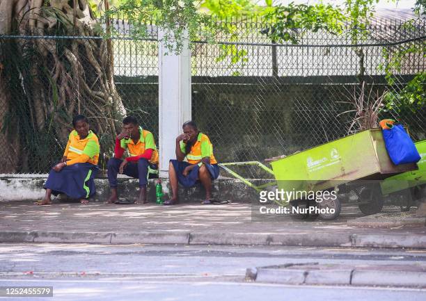 Street sweepers rest the street on International Workers' Day in Colombo on May 1, 2023. (Photo by Pradeep Dambarage/NurPhoto via Getty Images)
