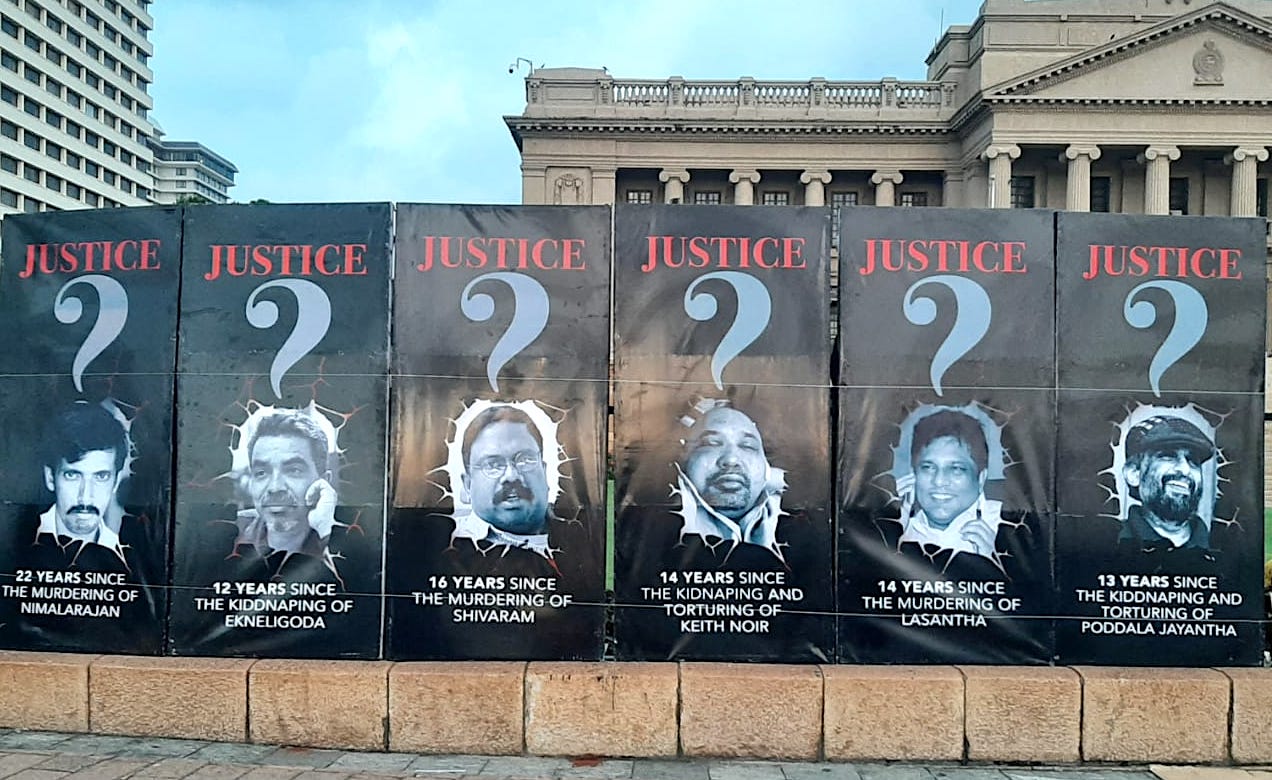 5 A banner with photos of slain and missing journalists outside the Presidential Secretariat yesterday evening. 1