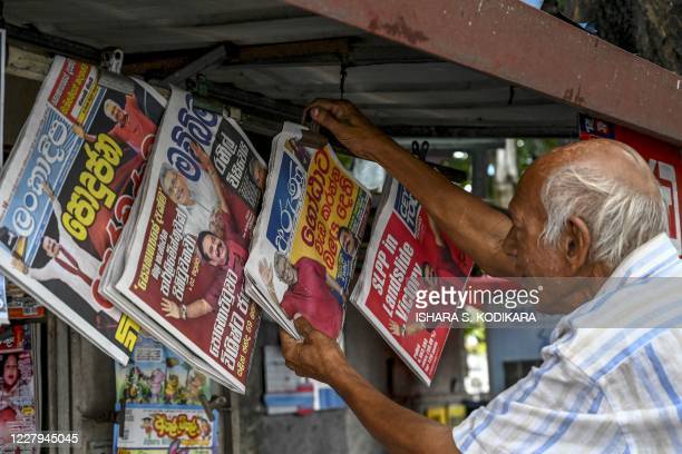A vendor displays newspapers for sale covering the results of Sri Lanka's parliamentary elections at a stall in Colombo on August 7, 2020. - Sri Lanka's ruling Rajapaksa brothers have secured a two-thirds majority in parliamentary elections, giving them powers to change the constitution and unravel democratic safeguards, final results showed on August 7. (Photo by ISHARA S. KODIKARA / AFP) (Photo by ISHARA S. KODIKARA/AFP via Getty Images)