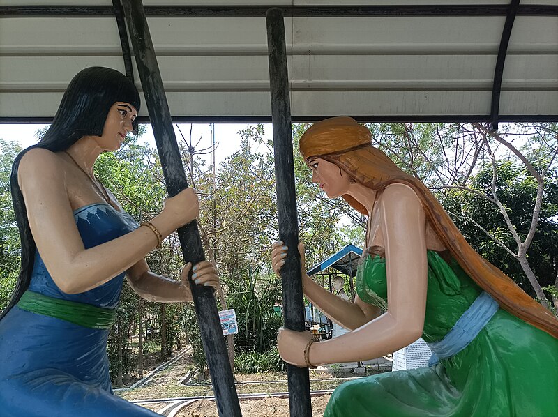 Statues of 2 Meitei women doing the ancient traditional practice of grinding pounding paddy rice using some unique kinds of large mortar and pestles Cultural heritages of Meitei civilization MMRC Unity Par