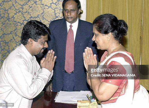 COLOMBO, SRI LANKA:  Sri Lankan President Chandrika Kumaratunga (R) greets the new minister for Agriculture, Livestock, Land and Irrigation, Anura Dissanayake (L) shortly after he was sworn in, 28 April 2004 at her official residence in the capital Colombo in an expansion of the cabinet with the induction of four Marxist legislators.  The Marxist JVP, or People's Liberation Front ended a stand off with Kumaratunga and accepted the portfolios allocated to them after their coalition narrowly won the 02 April 2004 parliamentary elections.  AFP PHOTO/ Sena VIDANAGAMA  (Photo credit should read SENA VIDANAGAMA/AFP via Getty Images)