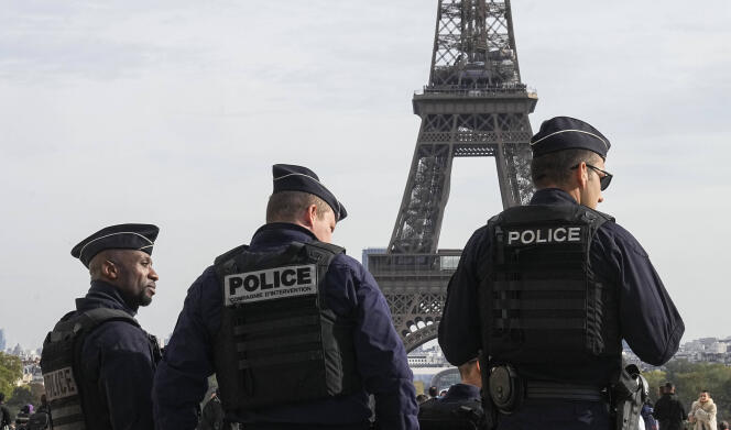 FILE - Police officers patrol the Trocadero plaza near the Eiffel Tower in Paris, Tuesday, Oct. 17, 2023. Police have arrested a man climbing on the Eiffel Tower. The drama temporarily stranded a crowd at the top. Among those trapped was a Washington, D.C., couple who decided during the wait to get married and an Associated Press reporter who got their story. Amir Khan had been planning to propose to Kate Warren later Thursday in a Paris garden away from the crowds, with a romantic dinner on the River Seine also on his menu.  (AP Photo/Michel Euler, File)/AMB111/23292667065035/FILE PHOTO, OCT. 17, 2023/2310192048