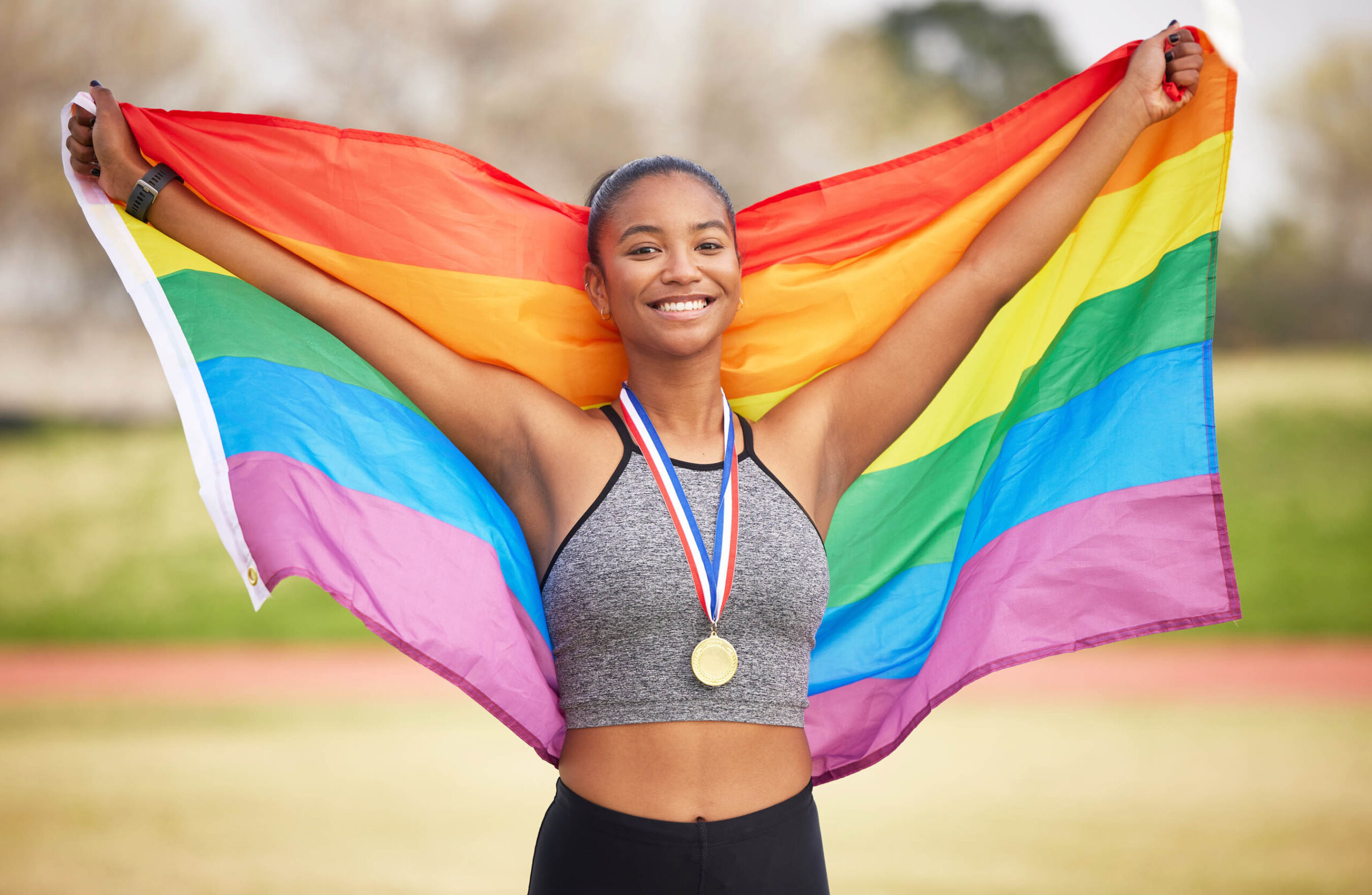 Rainbow flag, pride and portrait of a woman outdoor after winning a race, marathon or competition. Happy, smile and lesbian female athlete with lgbtq fabric for gay rights, equality or celebration.