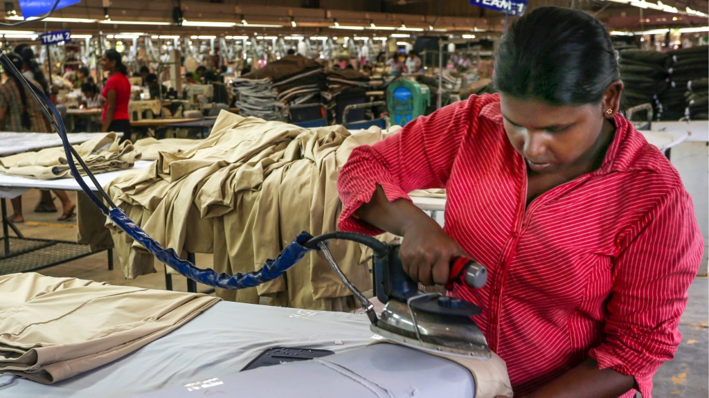 Ms Chathurika Nishamali, presses trousers made at Nordtex (Pvt) Ltd of Weliveriya, Friday, 29 August, 2014. The ADB supported Colombo port development has enabled most manufacturers and exporter to execute their orders on time or earlier than before thus paying dividends to the companies as well as their employees, in Sri Lanka.