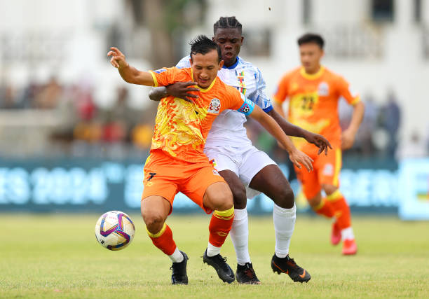COLOMBO, SRI LANKA - MARCH 22: Chencho Gyeltshen of Bhutan is challenged by Juste Koulou of Central African Republic during the FIFA Series 2024 Sri Lanka match between Central African Republic and Bhutan at Race Course Ground on March 22, 2024 in Colombo, Sri Lanka. (Photo by Pakawich Damrongkiattisak - FIFA/FIFA via Getty Images)
