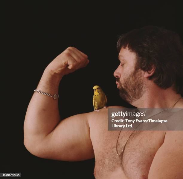 Athlete, strongman, and world class breeder of birds Geoff Capes, posing with a budgie, 1983. (Photo by Tony Evans/Getty Images)
