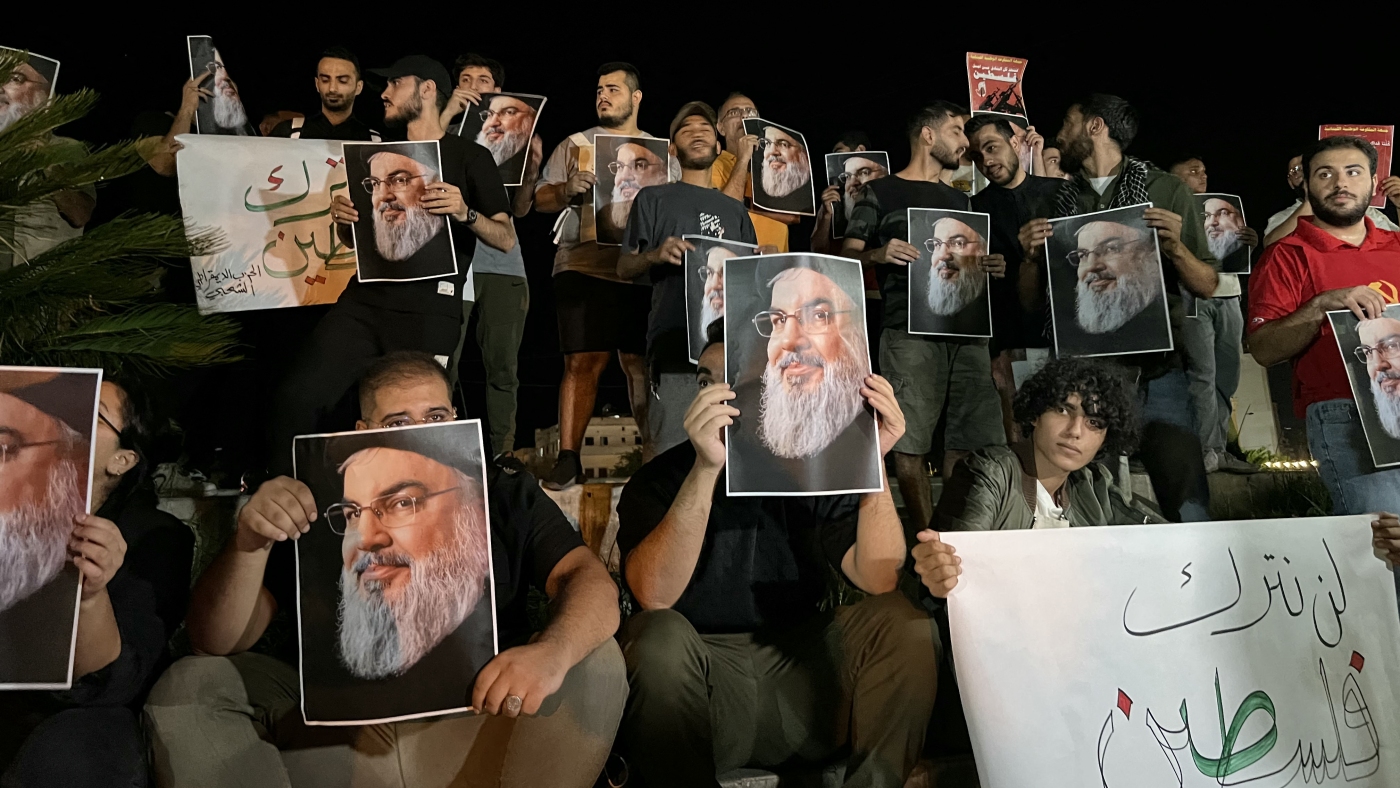 Demonstrators hold pictures of Hassan Nasrallah, late leader of the Lebanese group Hezbollah, during a protest vigil in the southern Lebanese city of Sidon on September 28, 2024. Lebanon announced three days of mourning for Hassan Nasrallah on September 28, after a huge Israeli air strike in Beirut's southern suburbs the previous day killed the Hezbollah leader. (Photo by Mahmoud ZAYYAT / AFP)
