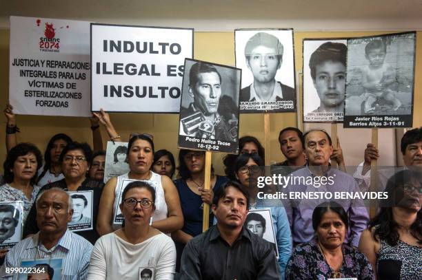 TOPSHOT - Relatives of the victims of Alberto Fujimori's regime and their lawyers attend a press conference in Lima on December 27, 2017. - Families of victims of former Peruvian president Alberto Fujimori prepared Wednesday to intensify protests against a pardon given to the ex-leader, who was serving 25 years for murder and other human rights abuses. They planned a fresh march on Thursday denouncing both the pardon and current President Pedro Pablo Kuczynski, who decreed Fujimori's release on Sunday, three days after narrowly surviving impeachment on graft allegations thanks to Fujimori's son Kenji. (Photo by ERNESTO BENAVIDES / AFP) (Photo by ERNESTO BENAVIDES/AFP via Getty Images)