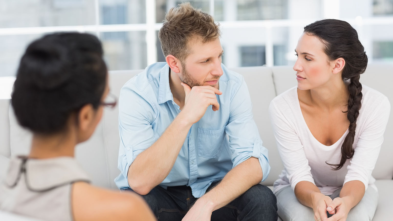 Unhappy couple at therapy session in therapists office