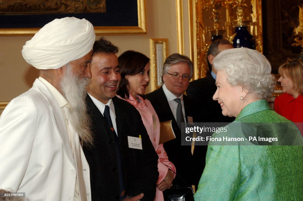 Fauja Singh (left) meeting the Queen at the Help The Aged Living Legends awards ceremony and reception hosted by Queen Elizabeth II at Windsor Castle.   (Photo by Fiona Hanson - PA Images/PA Images via Getty Images)