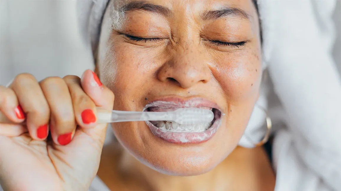 Female Brushing Teeth 1296x728 header 1296x728