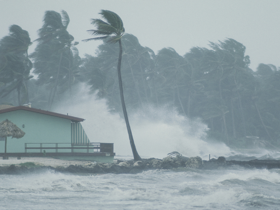 The powerful wind and rain of a hurricane pummel a building.