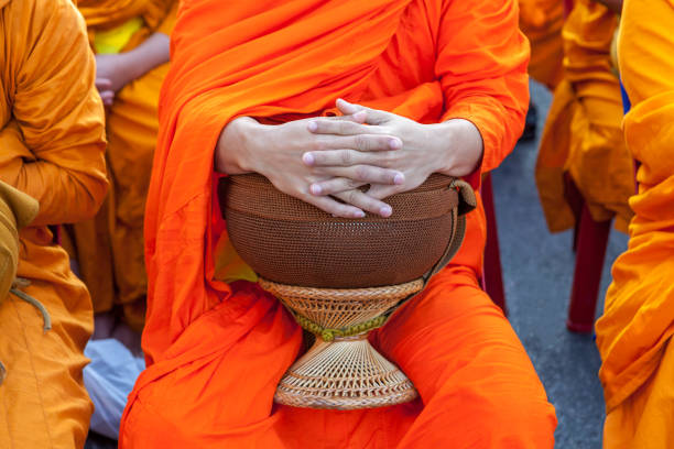 Buddhist monk's bowl in hands. Thai monk bowl for alms collection.