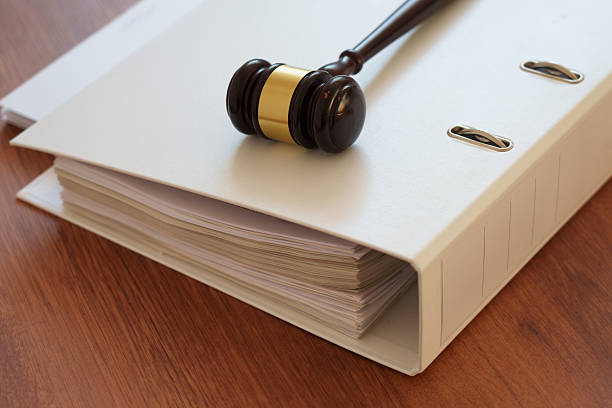 Folder of files with hammer on table
