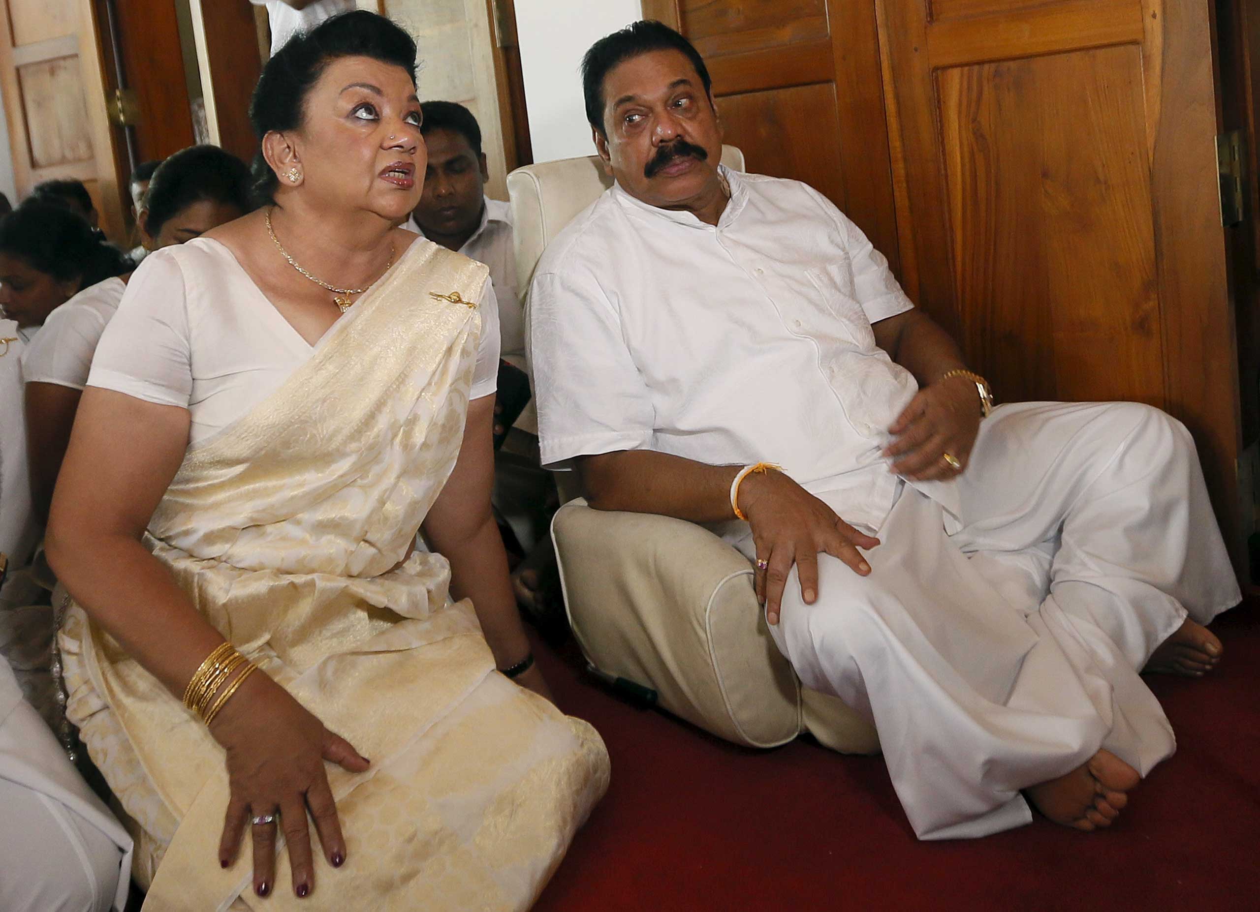 Former Sri Lankan president Mahinda Rajapaksa (R) sits next to his wife Shiranthi Rajapaksa during a religious ceremony at his residence in Medamulana July 1, 2015. Rajapaksa said he would run for prime minister during next month's parliamentary elections, a move that is likely to infuriate rights groups as he is accused of war crimes in a civil war. REUTERS/Dinuka Liyanawatte 
