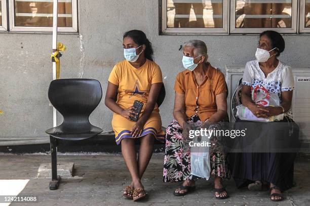 In this picture taken on July 19, 2022, patients wait for their appointment with medical staff outside a ward at the National Hospital in Colombo. - Entire wards are dark and nearly empty in Sri Lanka's largest hospital, its few remaining patients leaving untreated and still in pain, and doctors prevented from even arriving for their shifts. An unprecedented economic crisis has dealt a body blow to a free and universal healthcare system that just months earlier was the envy of the country's South Asian neighbours. - TO GO WITH Sri Lanka-economy-health,FOCUS by Parvaiz BUKHARI (Photo by AFP) / TO GO WITH Sri Lanka-economy-health,FOCUS by Parvaiz BUKHARI (Photo by -/AFP via Getty Images)