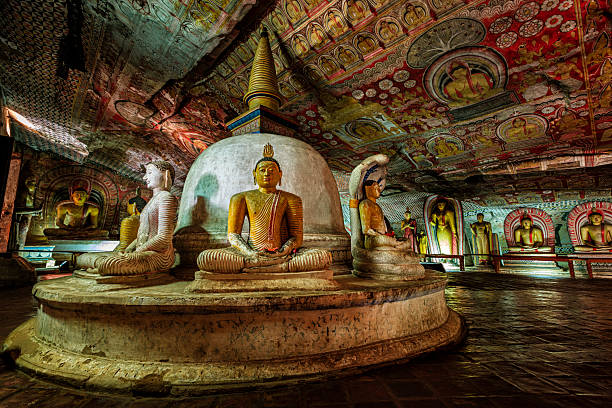 Buddha statue inside Dambulla cave temple, Sri Lanka. Dambulla cave temple also known as the Golden Temple of Dambulla is a World  Heritage Site in Sri Lanka, situated in the central part of the country. This site is situated 148 km east of Colombo and 72 km  north of Kandy. It is the largest and best-preserved cave temple complex in Sri Lanka. This temple complex dates back to the first century BCE. There are more than 80 documented caves in  the surrounding area. Major attractions are spread over 5 caves, which contain statues and paintings. These paintings and statues  are related to Lord Buddha and his life. There are total of 153 Buddha statues, 3 statues of Sri Lankan kings and 4 statues of  gods and goddesses.