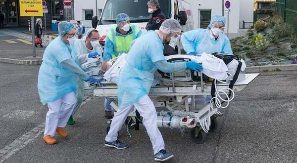 Medical staff push a patient on a gurney to a waiting medical helicopter at a hospital in eastern France on March 17 2020 amid the outbreak of the new Coronavirus. AFP
