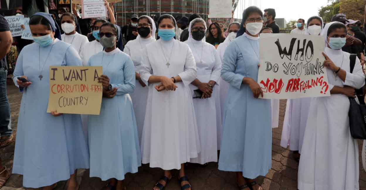 Catholic nuns holds placards against Sri Lanka's President Gotabaya Rajapaksa on a main road in Colombo on Monday. Photo: Reuters