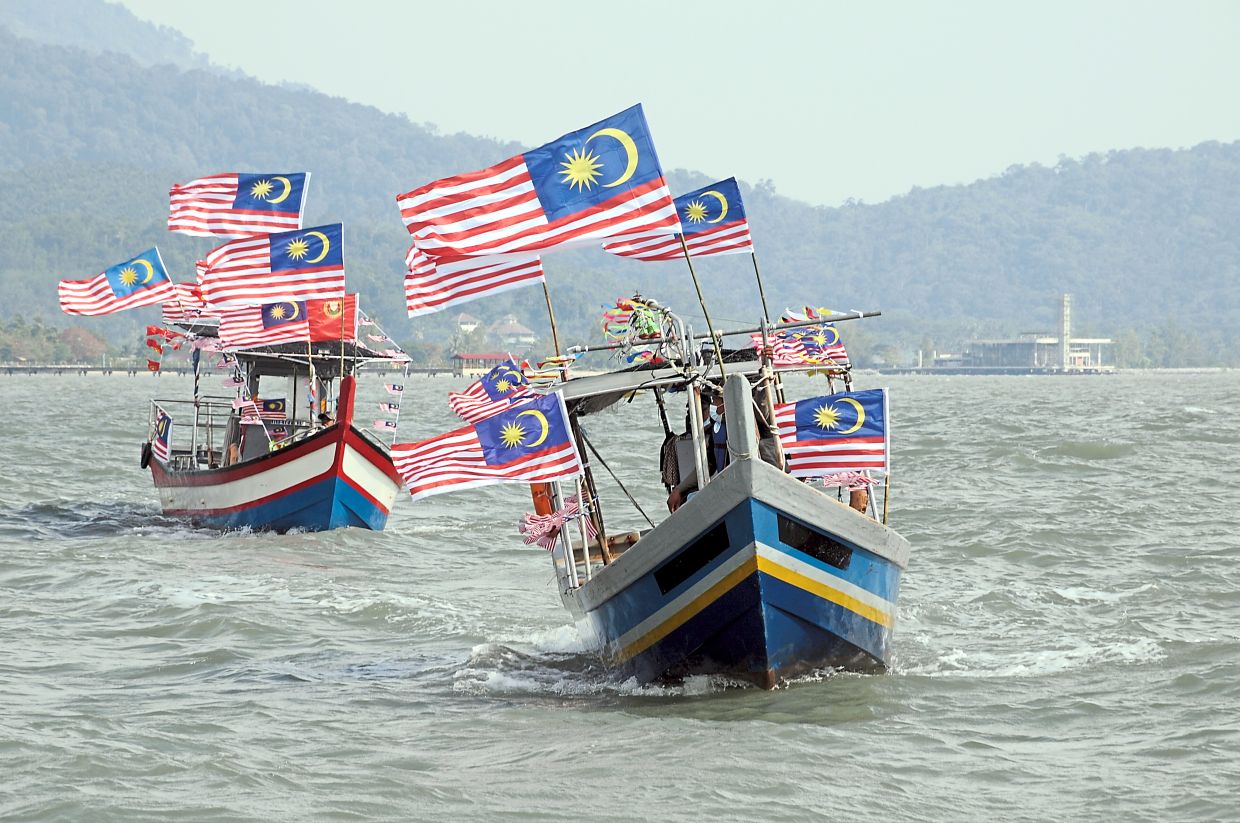 Two fishing boats decorated with many  various size of Jalur Gemilang and Kedah flags  were seen cruising at the sea at the coastal area of Yan during the Merdeka month merdeka spirit competition themed "Merdeka@Komuniti" - "Konvoi Merdeka Jalur Gemilang Bot Nelayan" event which was  held  and launched at  the jetty of  the Malaysia Fisheries Development Authority (LKIM) Complex at Kuala Sungai Udang in Yan, Kedah on Tuesday afternoon.(8th Sept).(Starpic by G.C.TAN/The Star-9th SEPT 2020)
