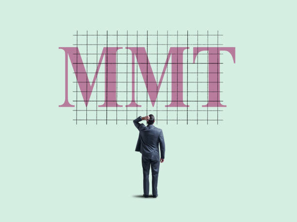 A businessman places his hind on top of his head as he looks up at a chart with the letters "MMT", which stands for Modern Monetary Theory on it.  Modern Monetary Theory is a contemporary monetary theory that suggests governments are not bound by traditional assumptions of government spending and debt.