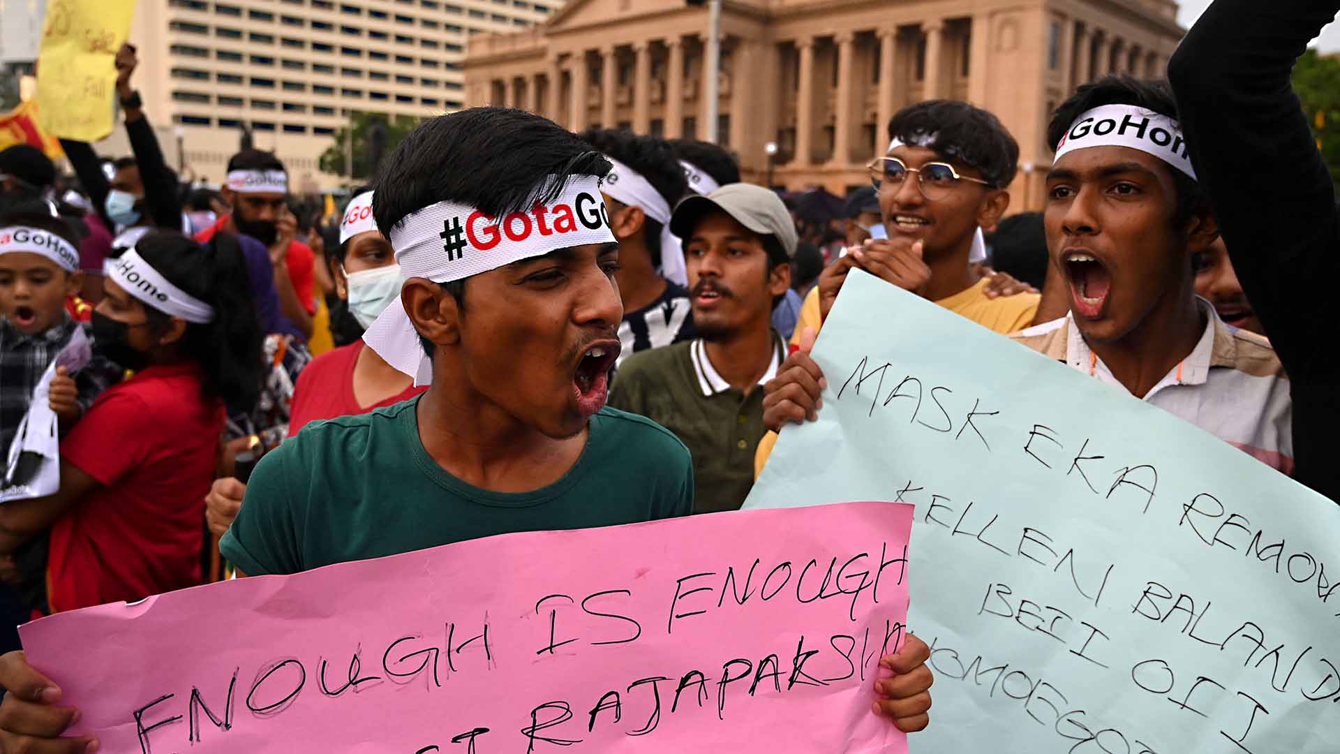 Demonstrators shout slogans and hold placards as they take part in a protest against the economic crisis at the entrance of the president's office in Colombo on April 10, 2022. - Severe shortages of food and fuel, alongside lengthy electricity blackouts, have led to weeks of widespread anti-government demonstrations with calls for President Gotabaya Rajapaksa to resign. (Photo by Ishara S. KODIKARA / AFP) (Photo by ISHARA S. KODIKARA/AFP via Getty Images)