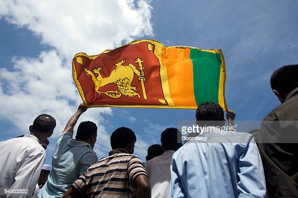 SRI LANKA - JUNE 03:  People hold up the Sri Lankan national flag at the National Victory Parade in Colombo, Sri Lanka, on Wednesday, June 3, 2009. Sri Lankan President Mahinda Rajapaksa said he won't allow a "shadow of separatism" in the country, as the government celebrated its victory over Tamil Tiger rebels with a military parade in the capital, Colombo.  (Photo by Adeel Halim/Bloomberg via Getty Images)